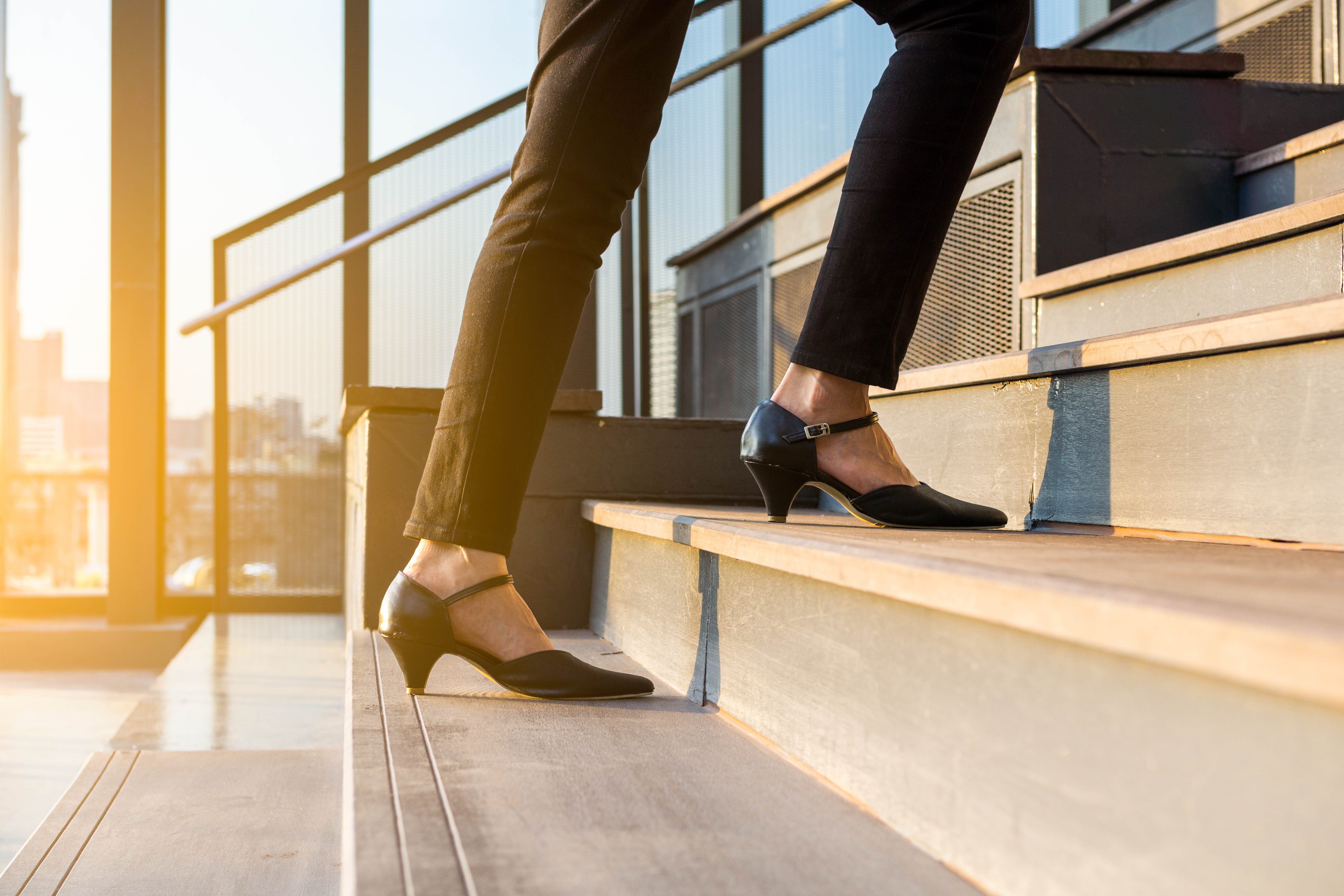Woman walks upstairs outside, close-up on her short heels Woman walks upstairs outside, close-up on her short heels